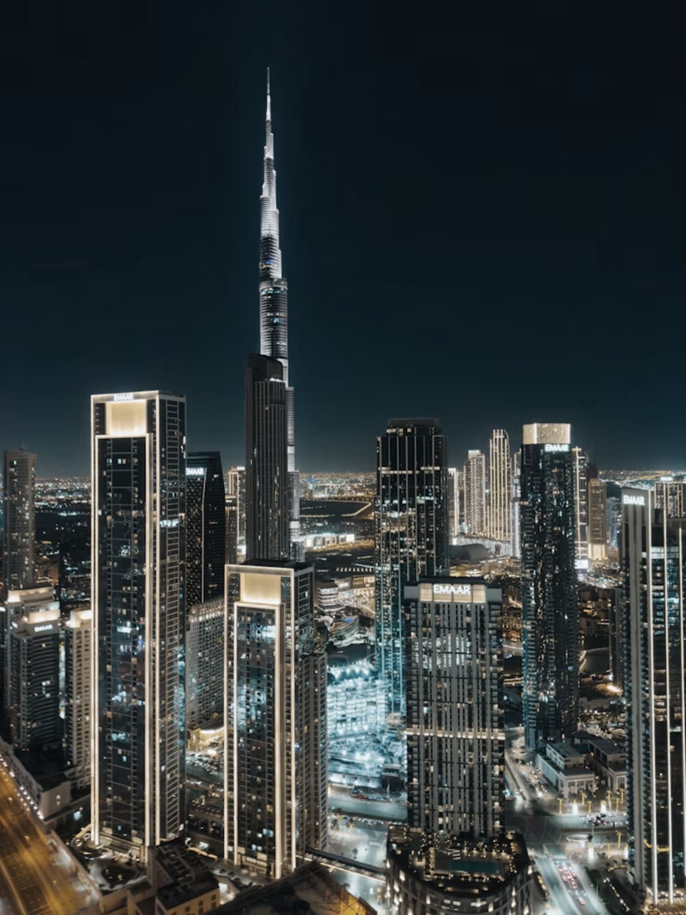 Downtown Dubai at night, with the Burj Khalifa rising above the towers